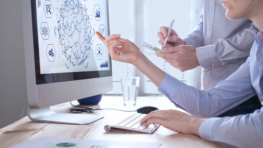 Data analysts working on data analytics and visualization with machine learning on computer screen in modern office. Data science in business, finance and innovation.